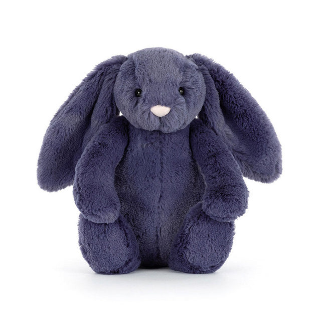 A soft, plush, dark blue bunny with long floppy ears sits facing forward.