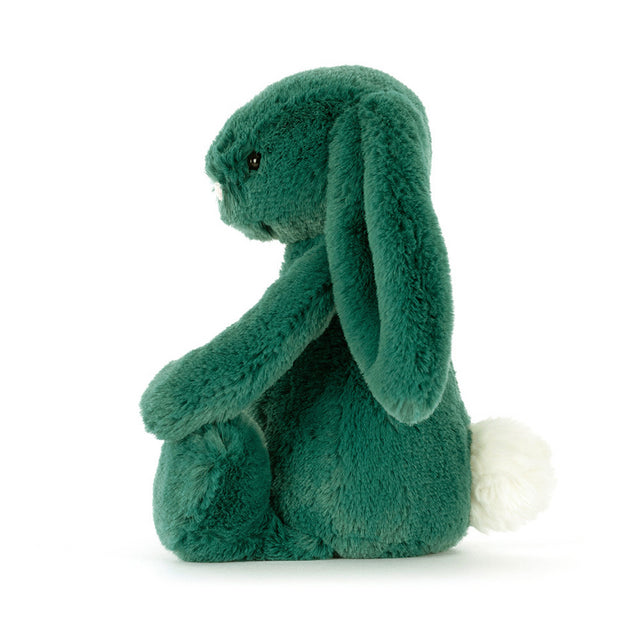 A teal plush bunny with long floppy ears and a white fluffy tail sits facing left.