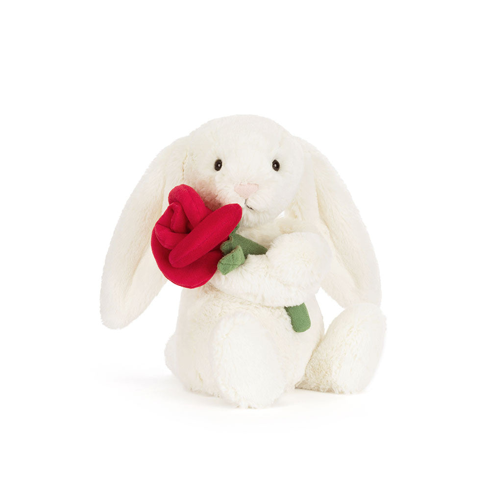 Cream bunny plush toy holding a red rose.