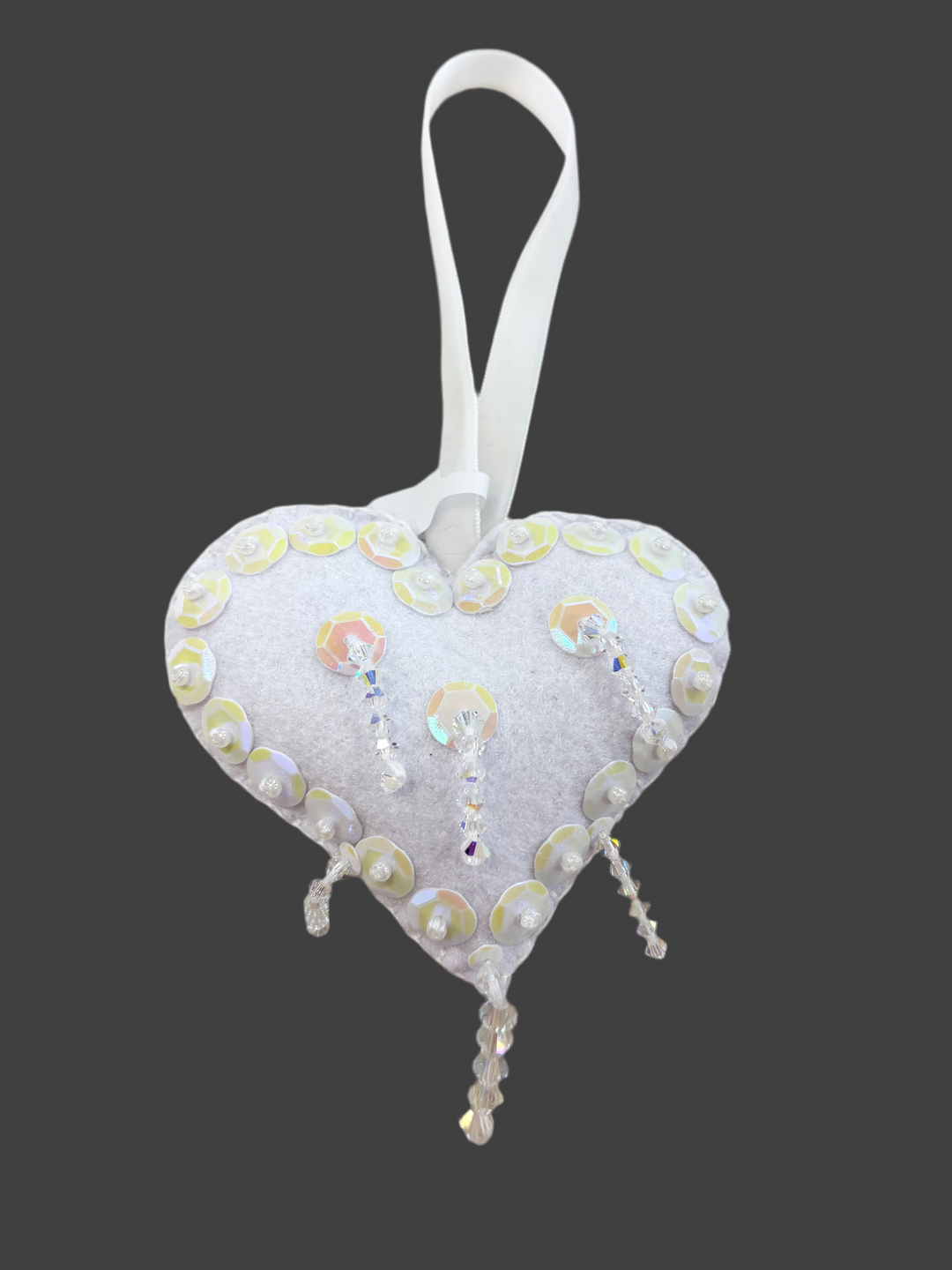 White felt heart ornament with iridescent sequins and clear beaded fringe.