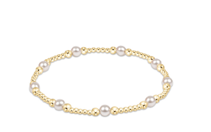 A gold beaded bracelet with evenly spaced white pearls.