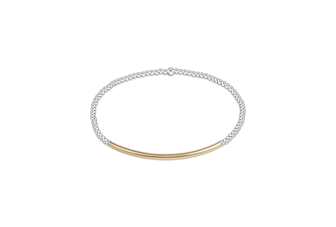 A sterling silver beaded bracelet with a central gold bar.