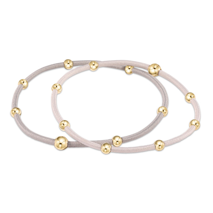 Two neutral-colored elastic hair ties with gold-filled beads.