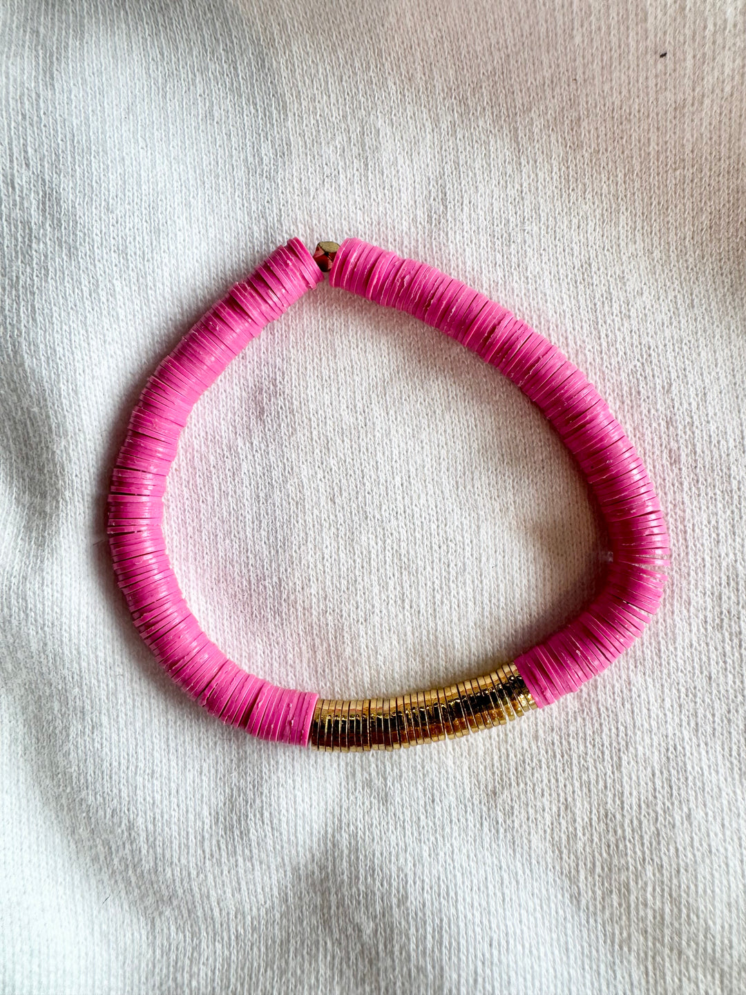 Large flat bead bracelet with pink vinyl beads and a section of gold-plated beads.