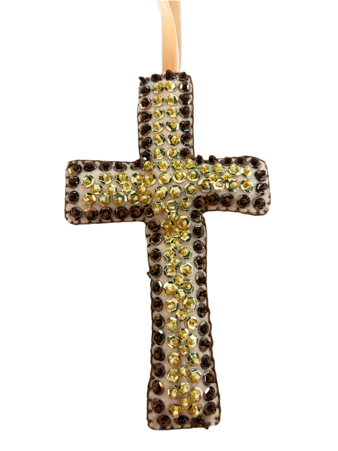 Large cross ornament, hand-beaded with gold and brown sequins, hanging from a beige ribbon.