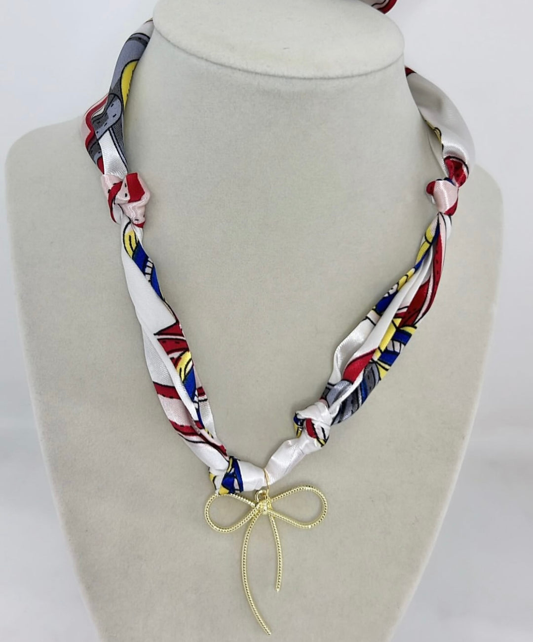 Emily Bow Satin Scarf Necklace with a gold bow charm.