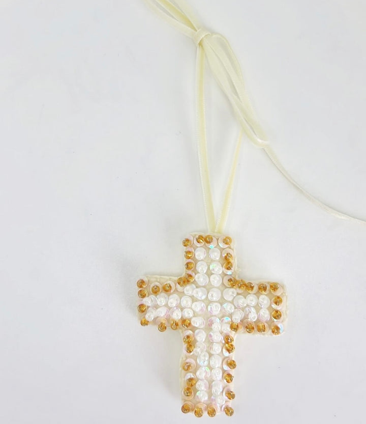 Mini Cross Hand Beaded Ornament with white and gold beads on a white ribbon.