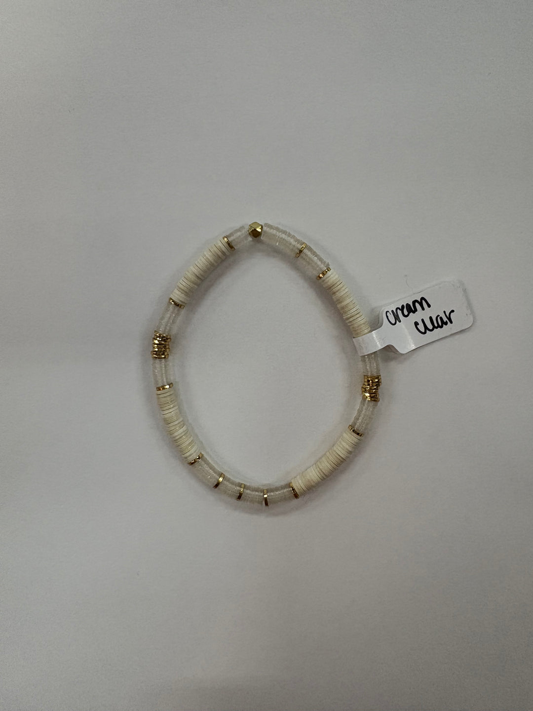 Small flat bead bracelet with white and clear beads, and gold accents.