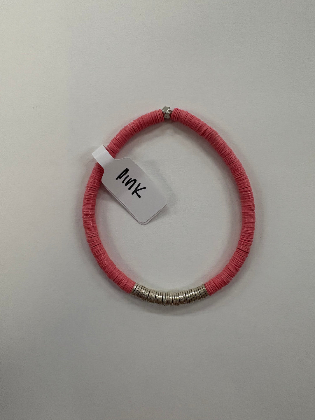Pink flat bead bracelet with silver-plated accents and a tag reading "Pink."