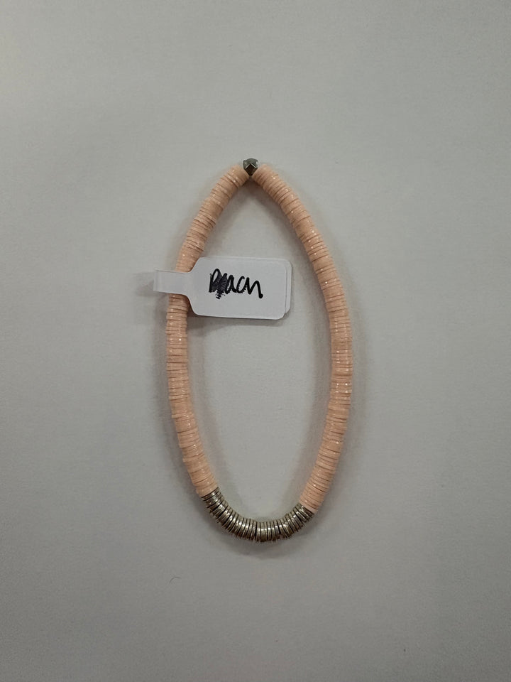 Small flat bead bracelet with peach vinyl beads and silver-plated accents.