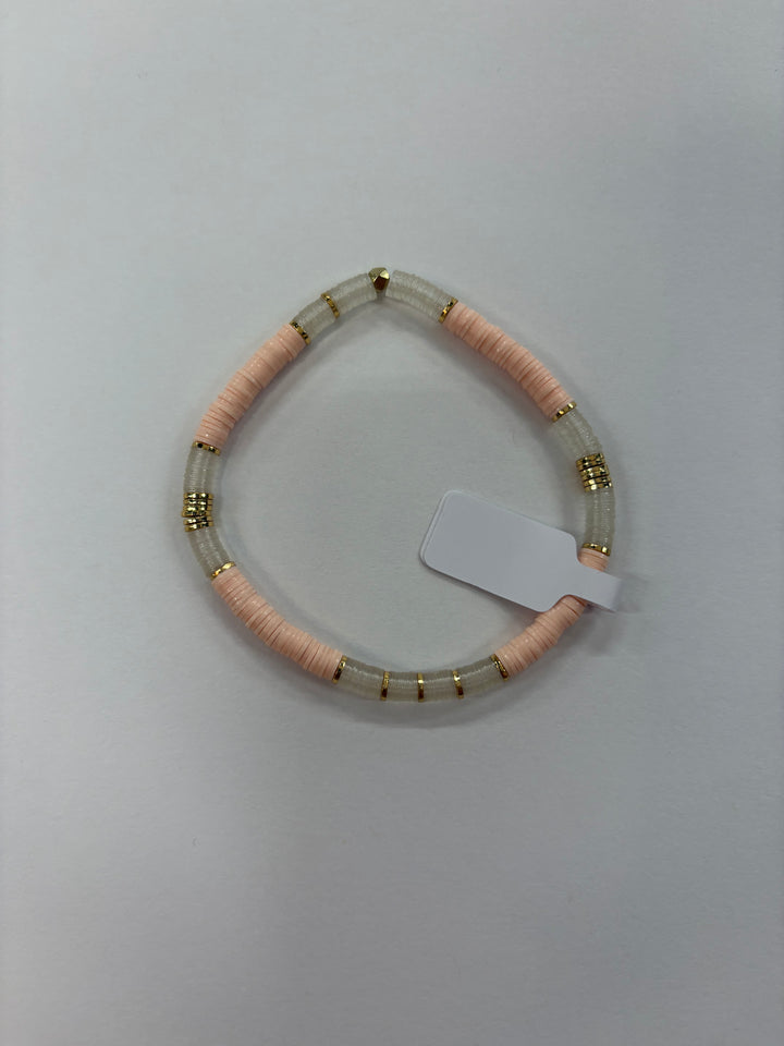 Small flat bead bracelet with pink and clear vinyl beads and gold accents.