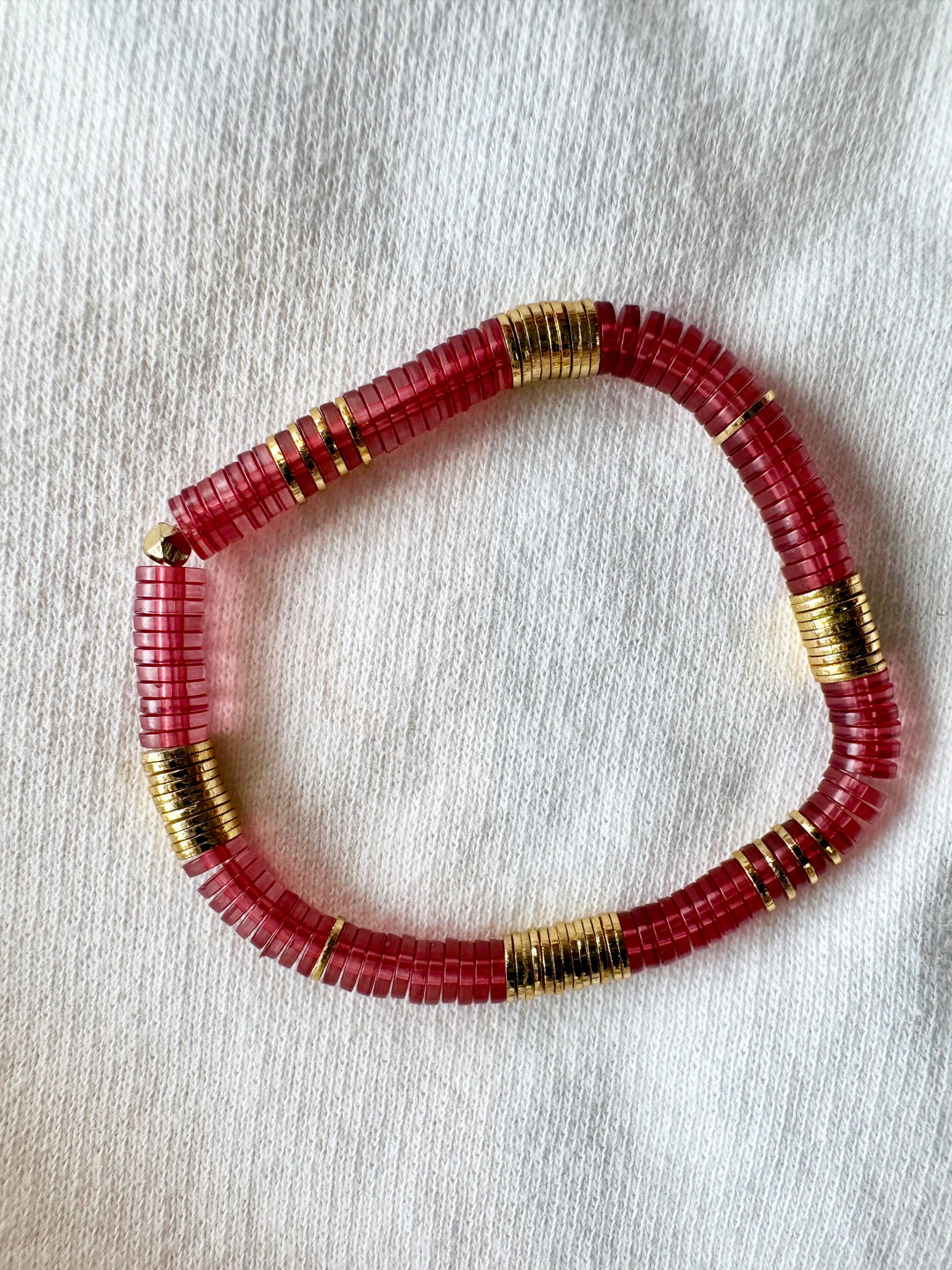 Large flat bead bracelet with red vinyl and gold-plated beads.