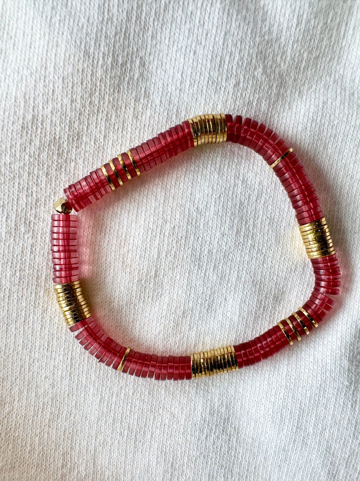 Large flat bead bracelet with red vinyl and gold-plated beads.
