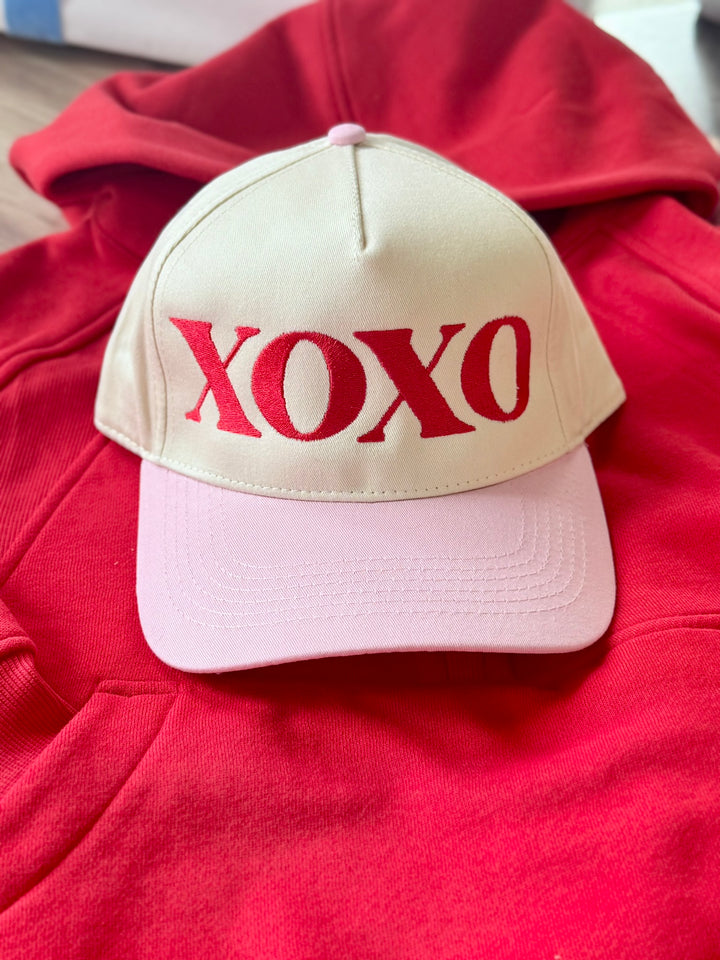 XOXO embroidered hat with a cream crown and pink brim.