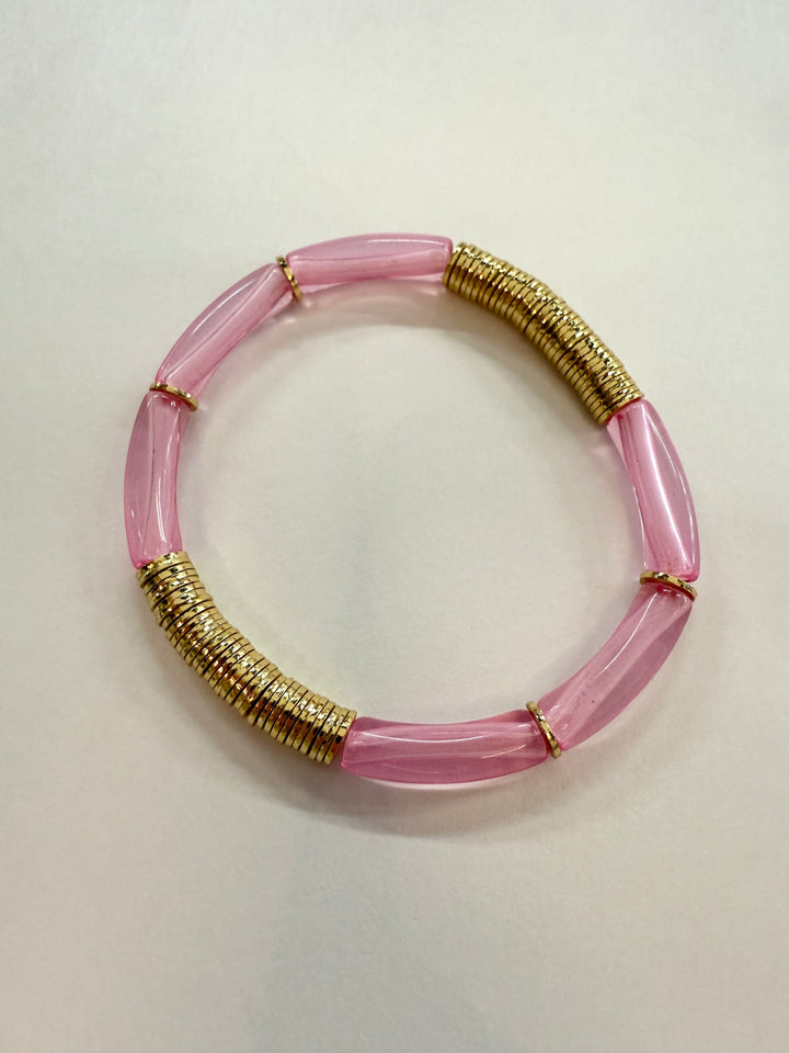 Pink noodle bracelet with gold-plated disc beads.