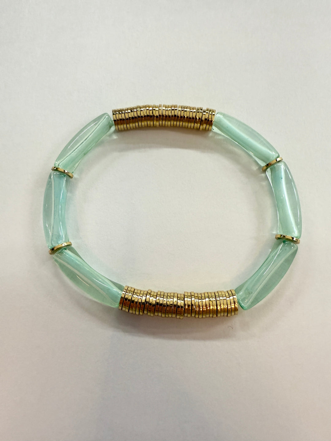 Noodle bracelet with light green acrylic beads and gold-plated disc beads.