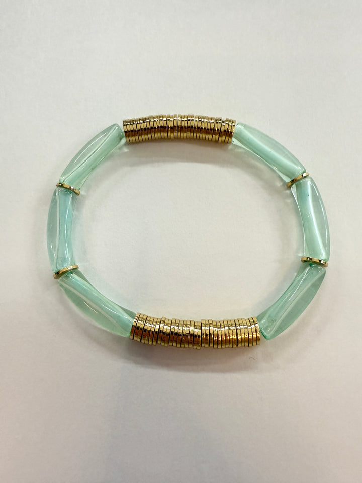 Noodle bracelet with light green acrylic beads and gold-plated disc beads.