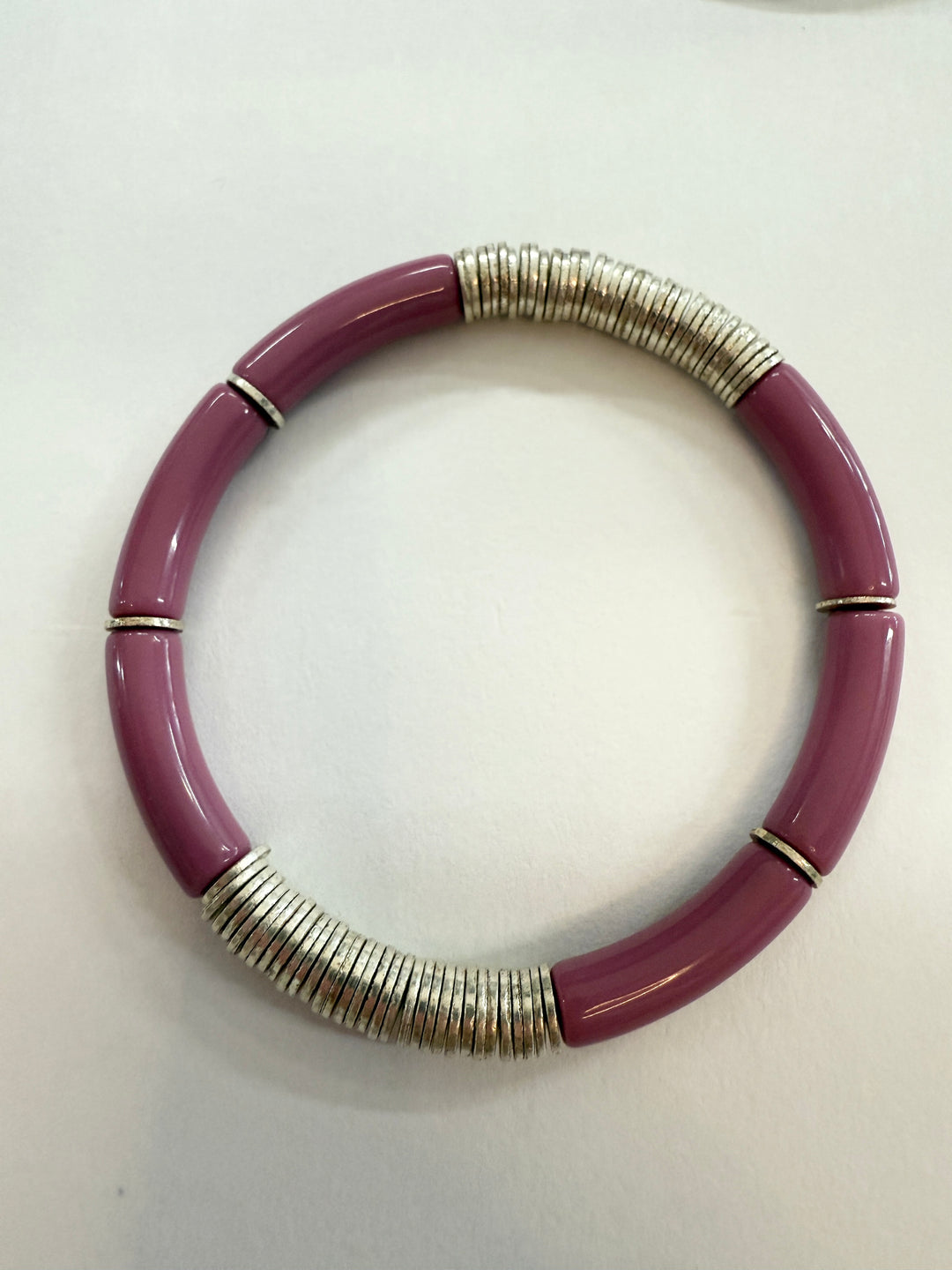 A purple noodle bracelet with silver-plated disc beads.