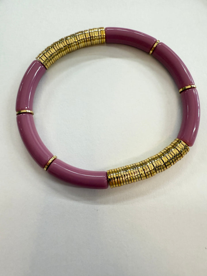 A purple and gold noodle bracelet.