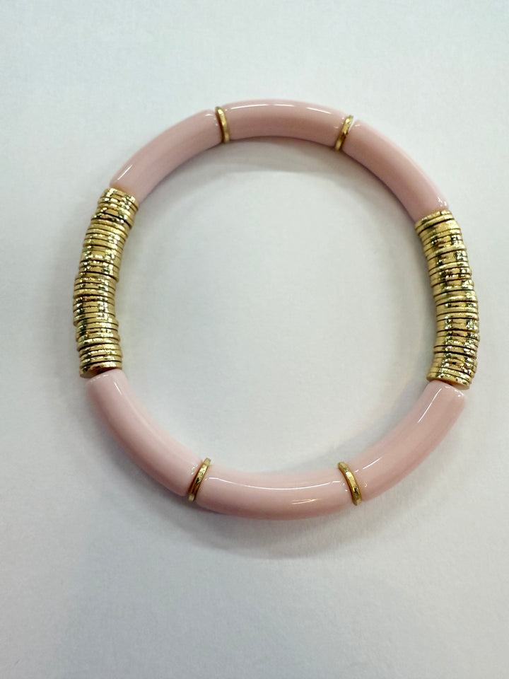 Pink noodle bracelet with gold disc beads.