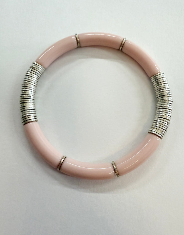 A light pink noodle bracelet with silver-plated disc beads.