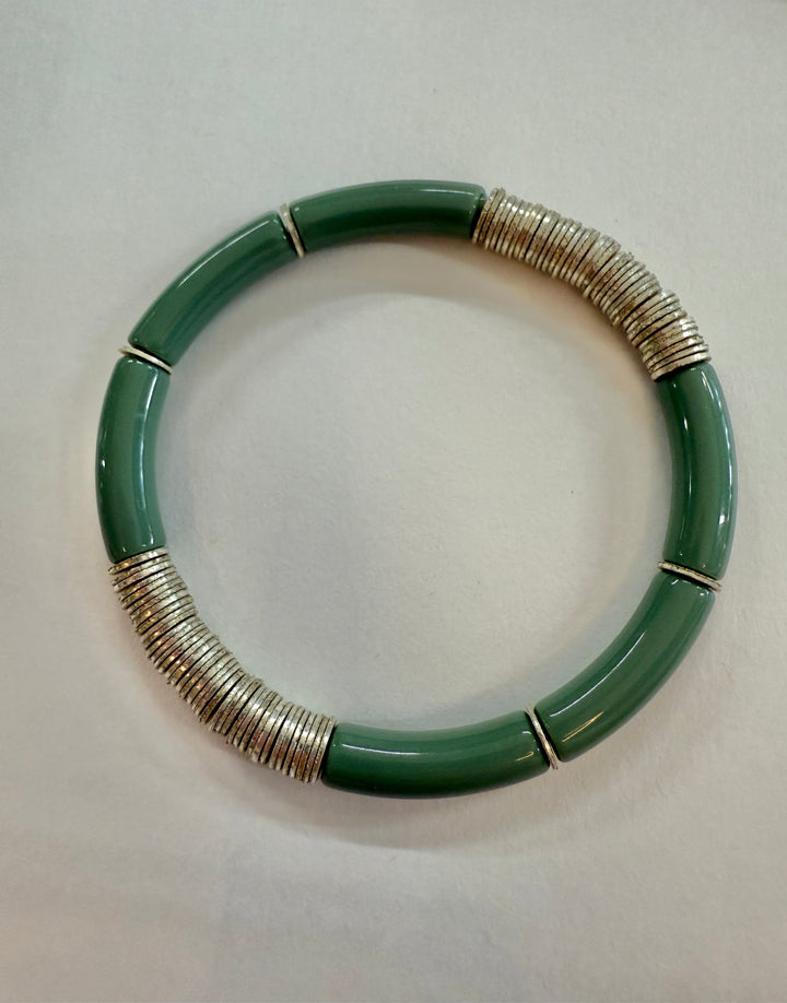 A green noodle bracelet with silver-plated disc beads.