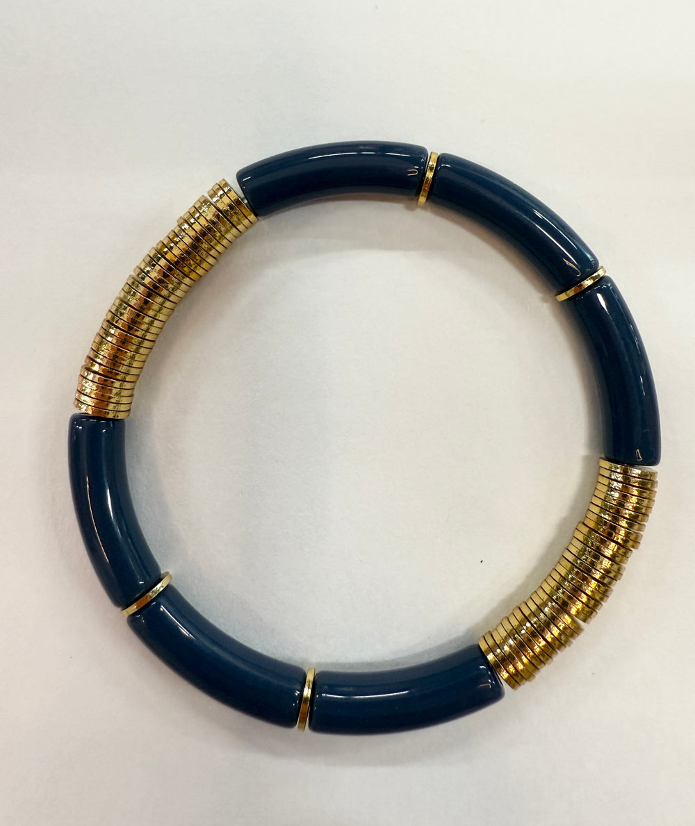Noodle bracelet with alternating navy blue acrylic and hammered gold-plated disc beads.