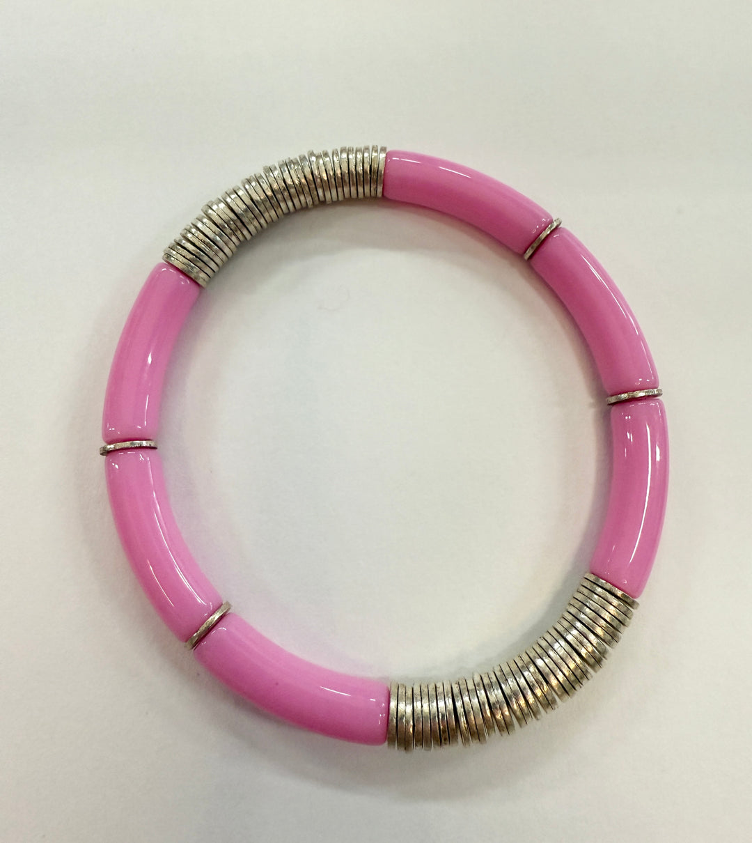 A pink noodle bracelet with silver-plated disc beads.