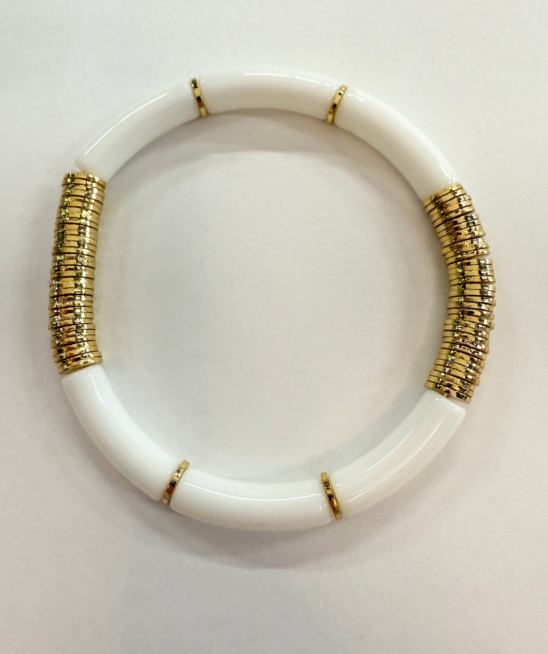 White noodle bracelet with gold disc beads.