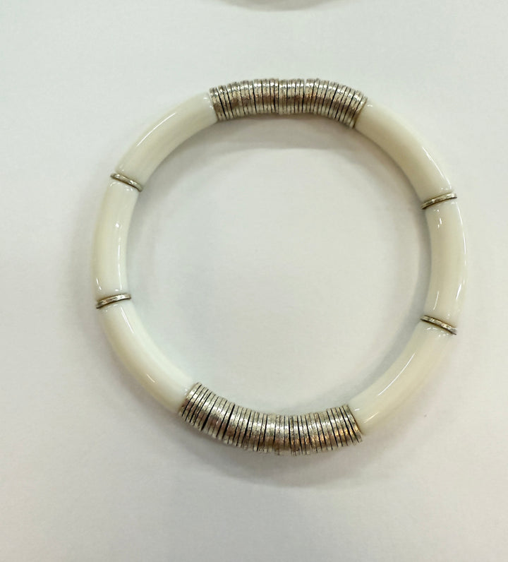 White noodle bracelet with silver-plated disc beads.