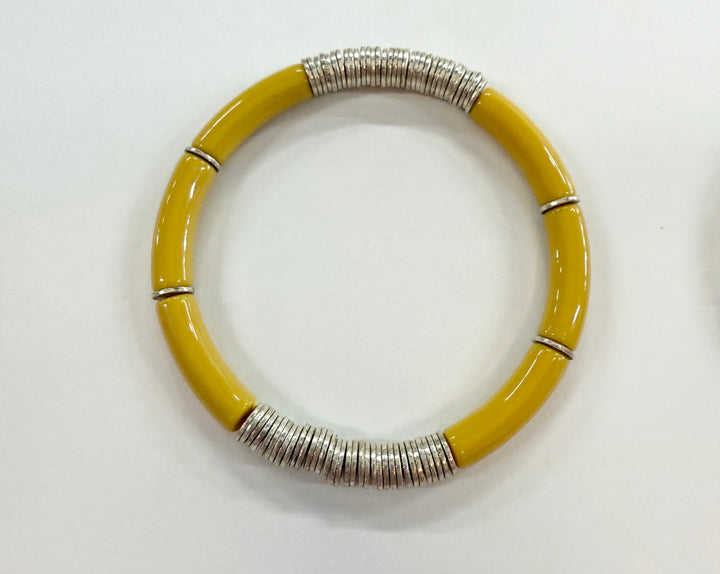 Noodle bracelet with yellow acrylic beads and silver-plated disc beads.