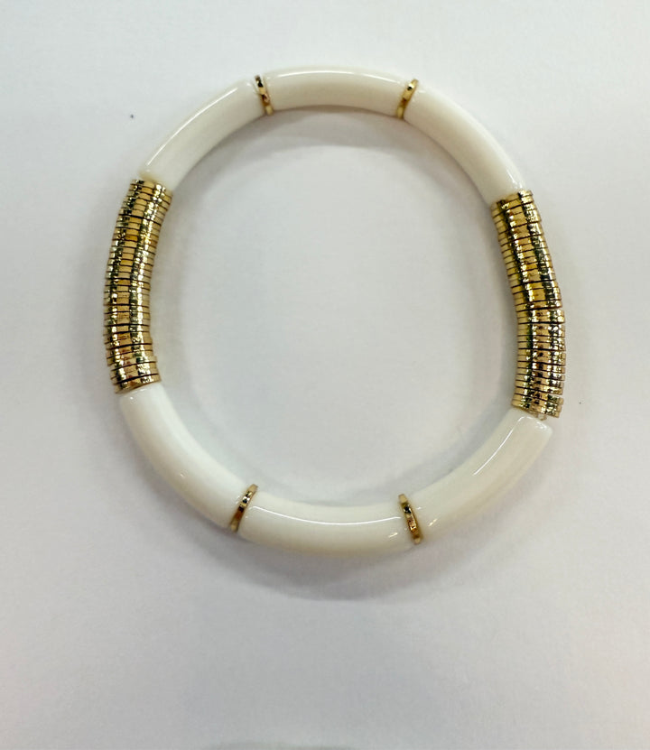 White noodle bracelet with gold-plated disc beads.