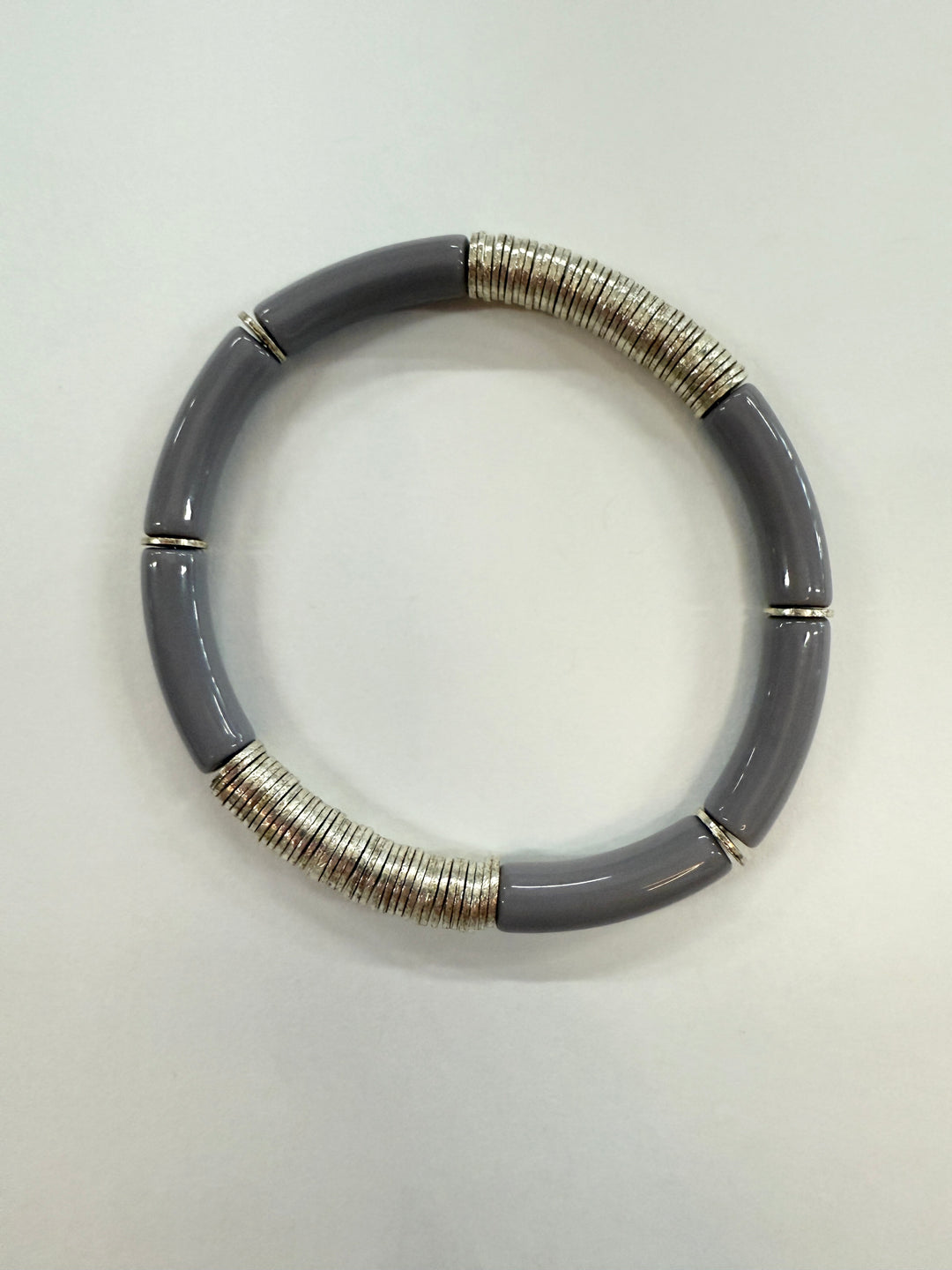 A gray noodle bracelet with silver-plated disc beads.