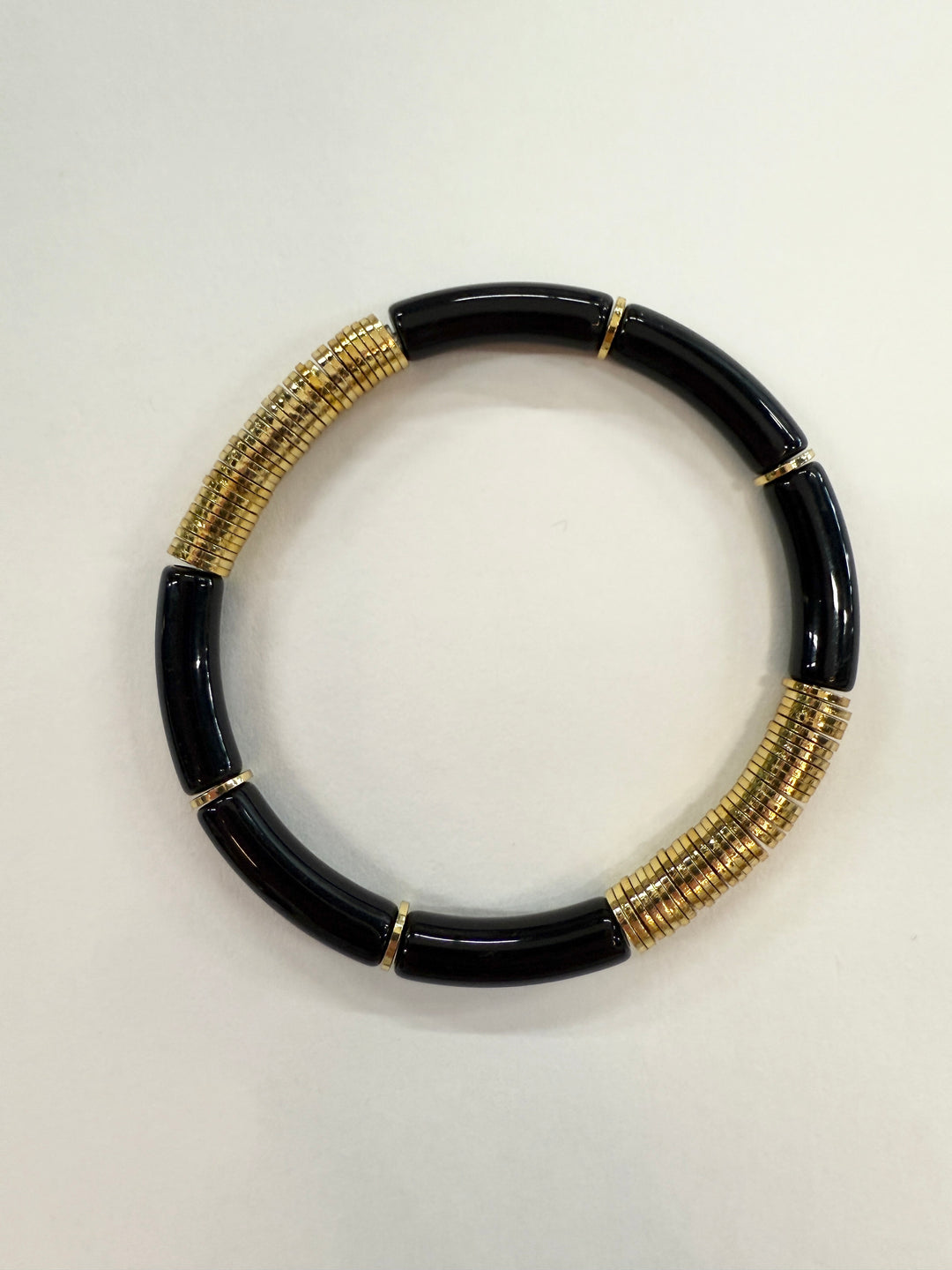 Black and gold noodle bracelet.