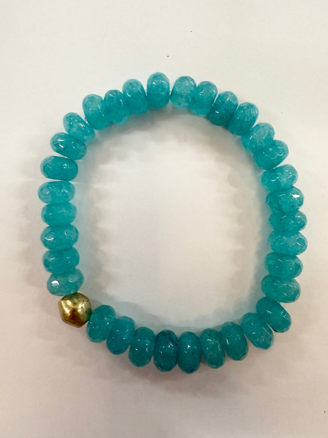 Jade bead bracelet with a single gold-colored bead.