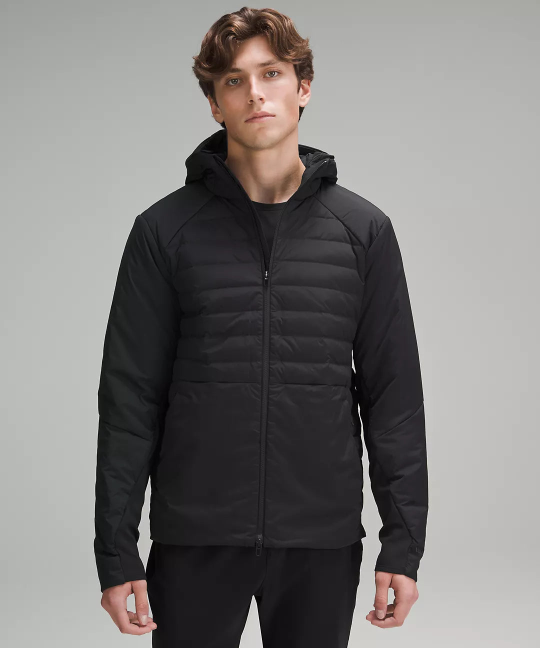 Black hooded puffer jacket with contrasting sleeves.