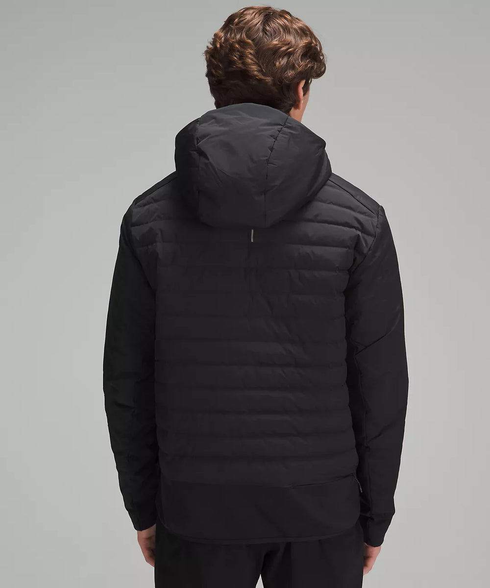 Back view of a black hooded puffer jacket with horizontal quilting.