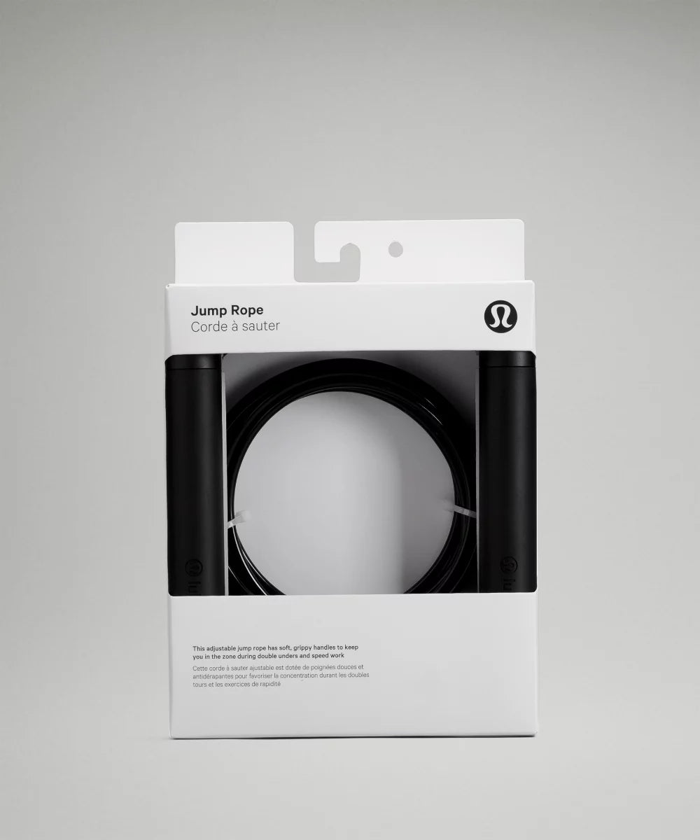 Jump Rope with black handles and a coiled black rope inside its packaging.