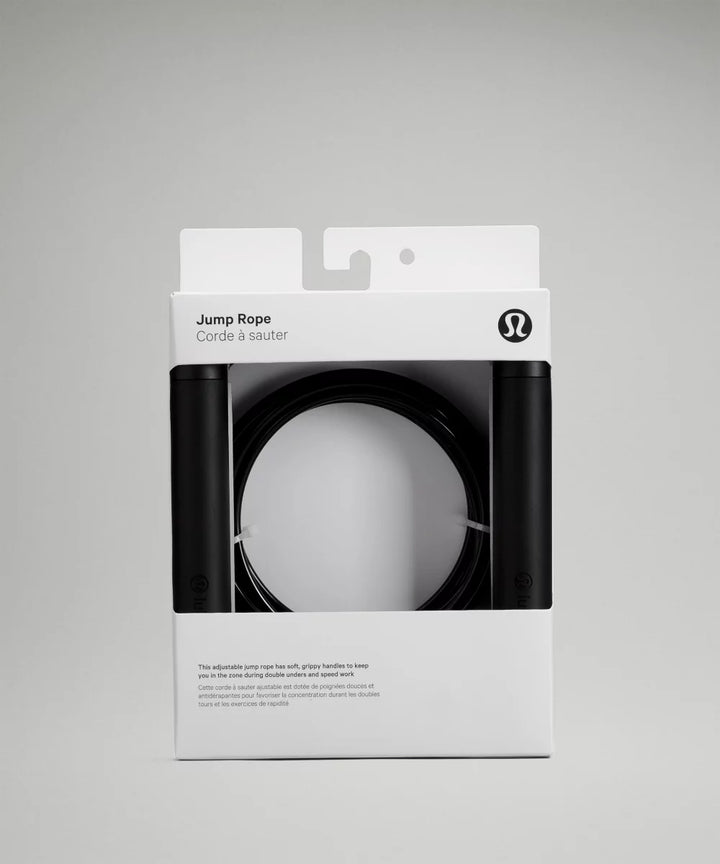 Jump Rope with black handles and a coiled black rope inside its packaging.