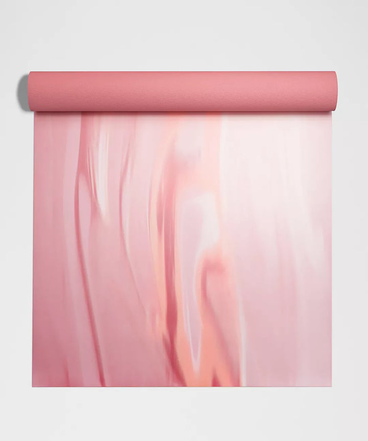 A pink yoga mat with a marbled pattern.