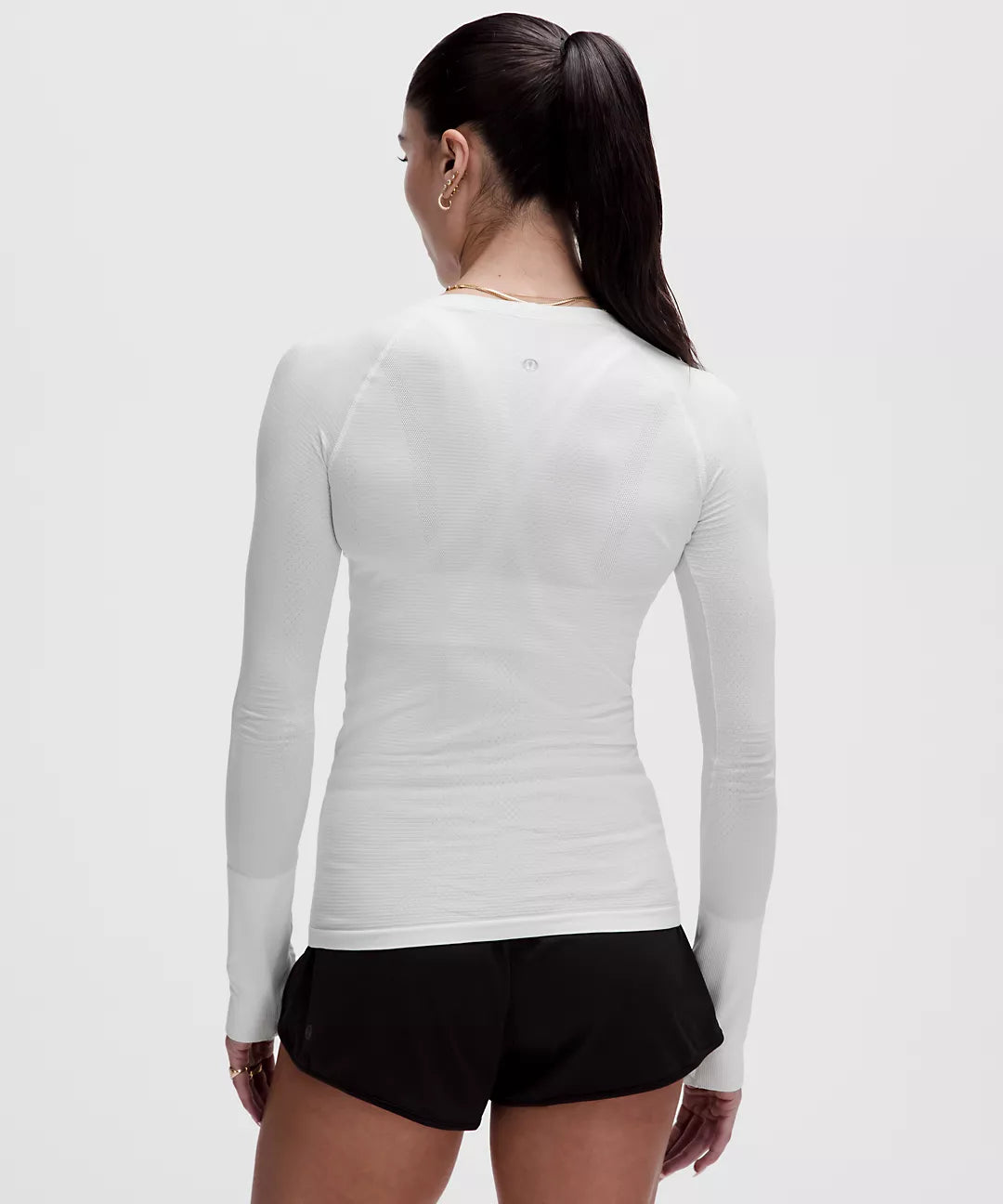 White seamless long-sleeve athletic shirt with thumbholes.