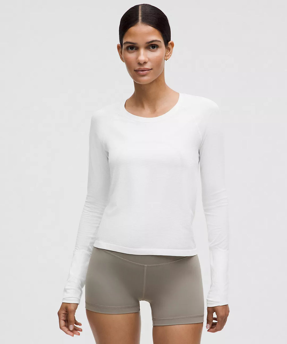 White long-sleeve athletic shirt with a crew neck.