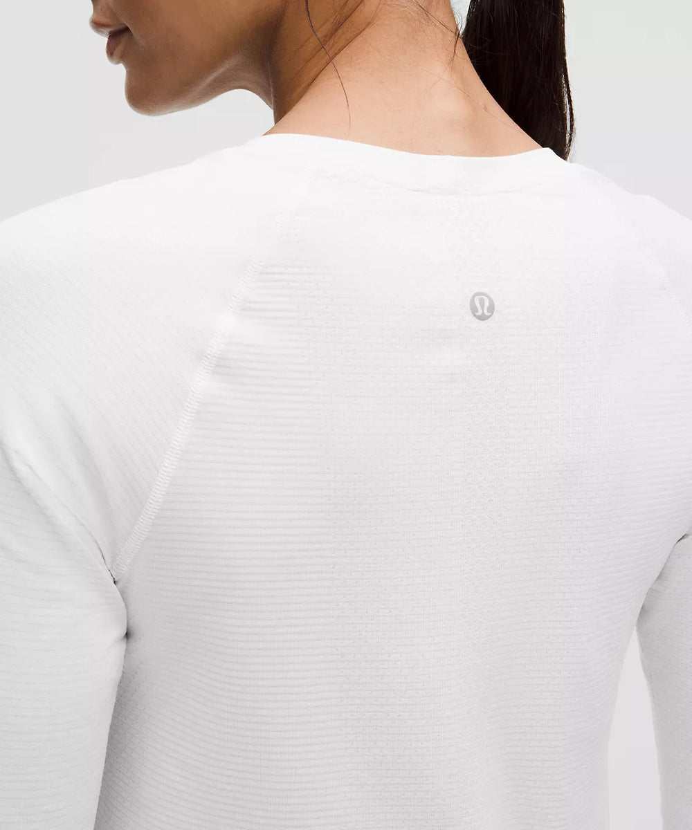 White long-sleeve shirt with a grey logo on the back.
