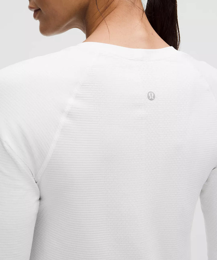 White long-sleeve shirt with a grey logo on the back.