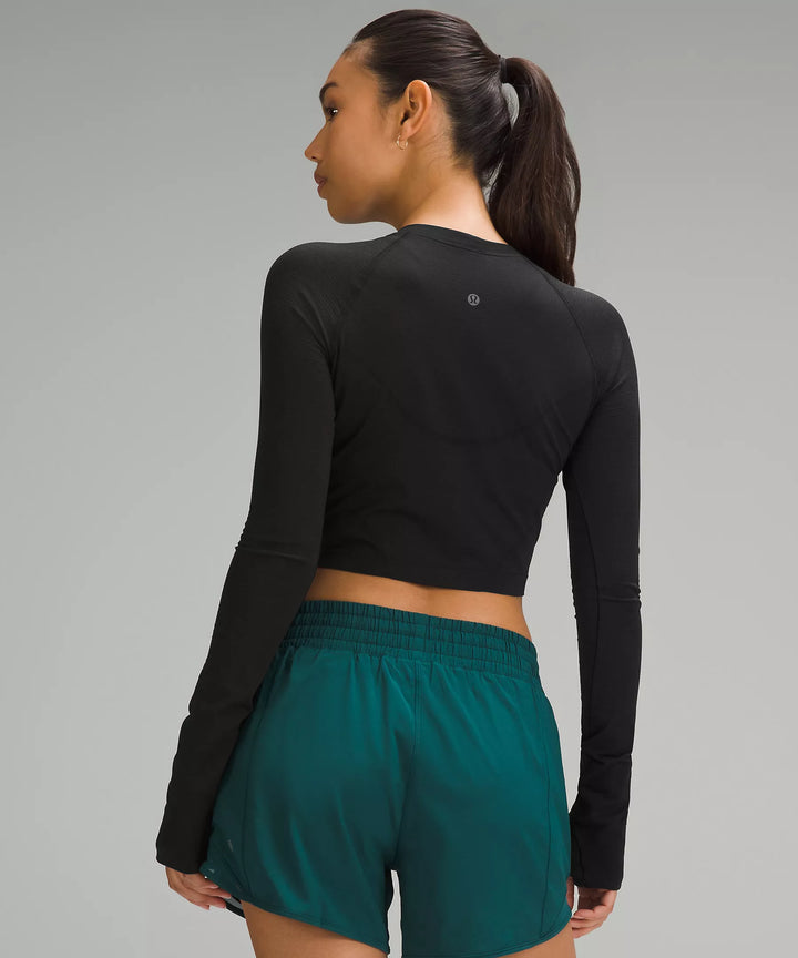 Black cropped long-sleeve shirt with thumbholes.