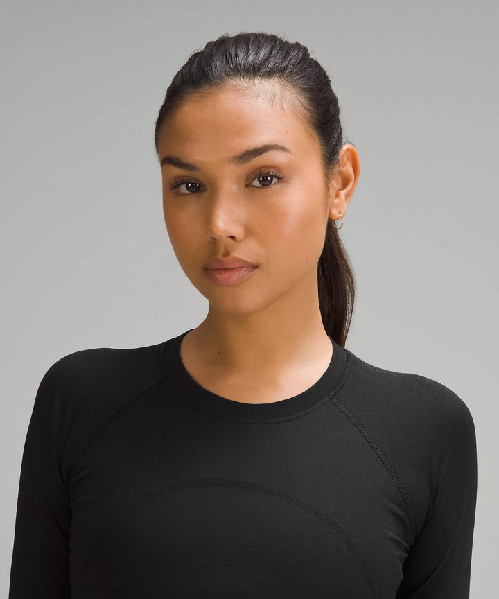 Black long-sleeve cropped shirt with subtle texture details.