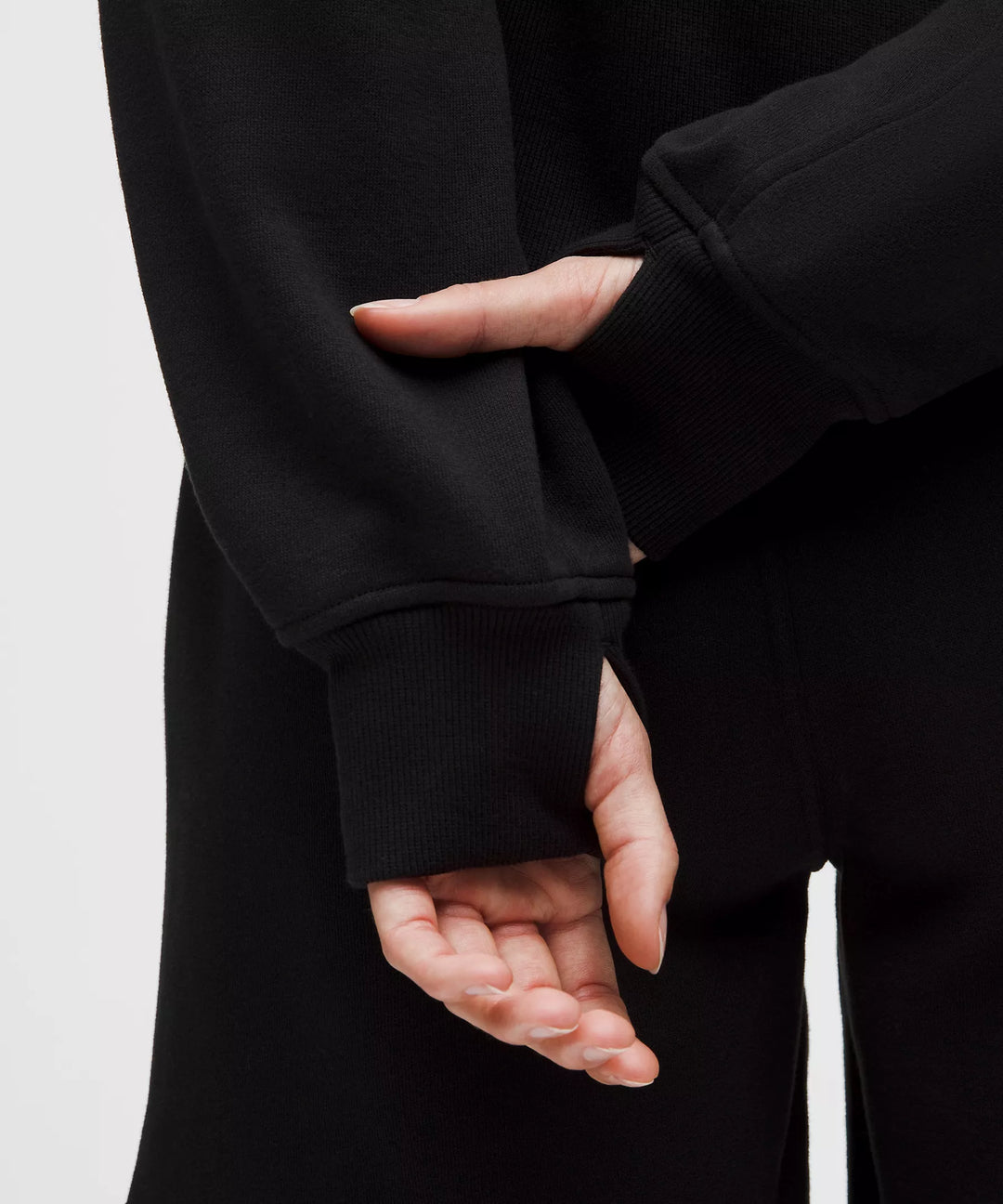 Black oversized full-zip hoodie with thumbholes and ribbed cuffs.