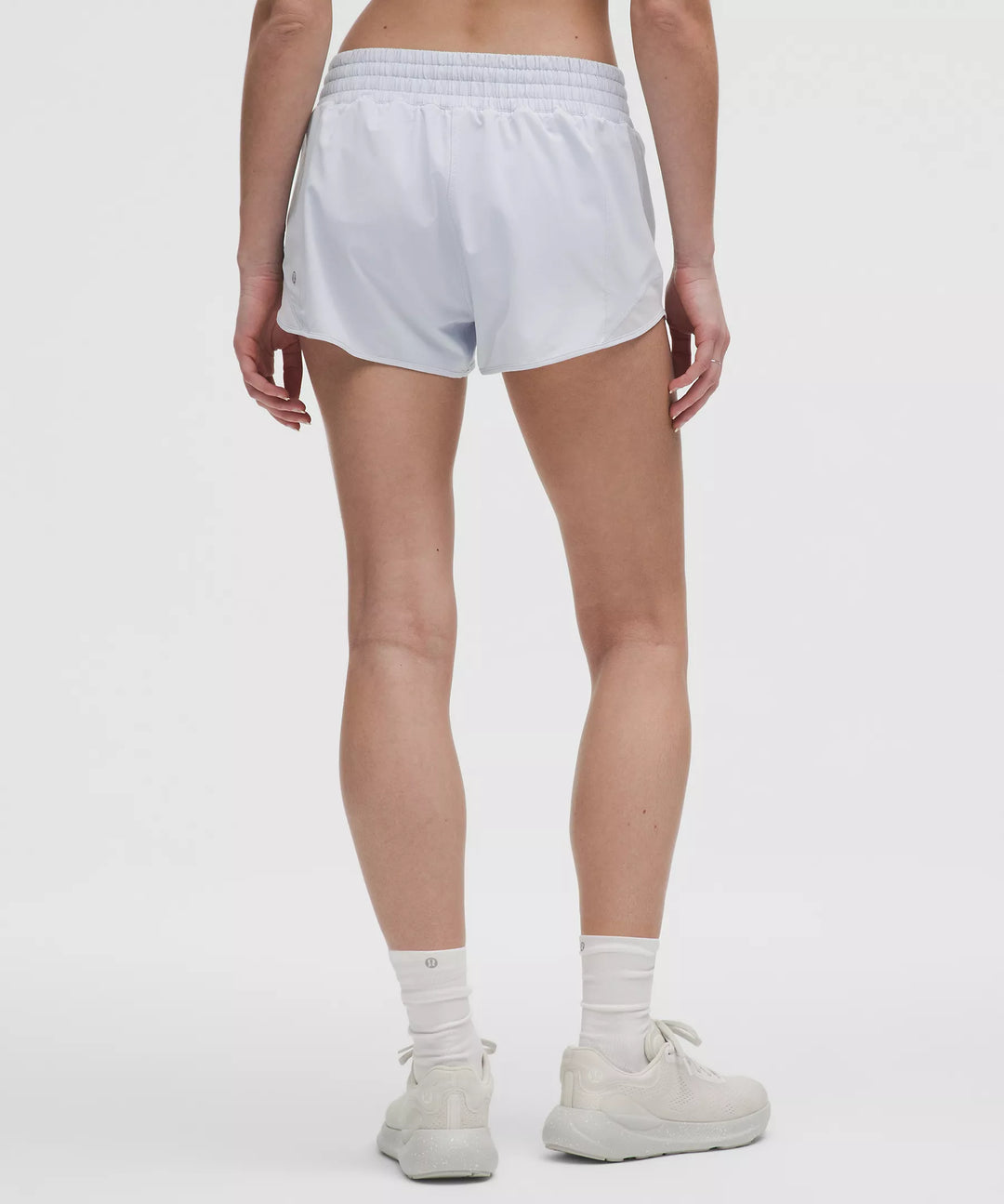 Starch blue high-rise lined shorts with a wider leg, worn with white socks and sneakers.