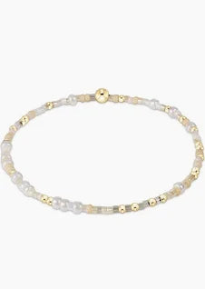 A delicate bracelet with small, mixed-color beads and gold accents.