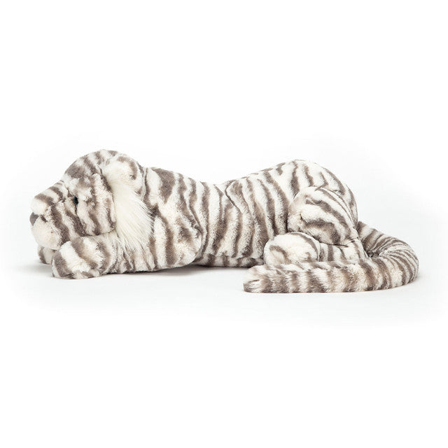 A plush Sacha Snow Tiger toy with grey and cream stripes lies on a white background.